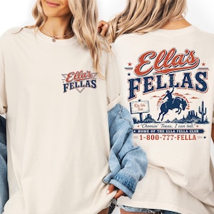 two women wearing white t-shirts with a graphic design on the back.