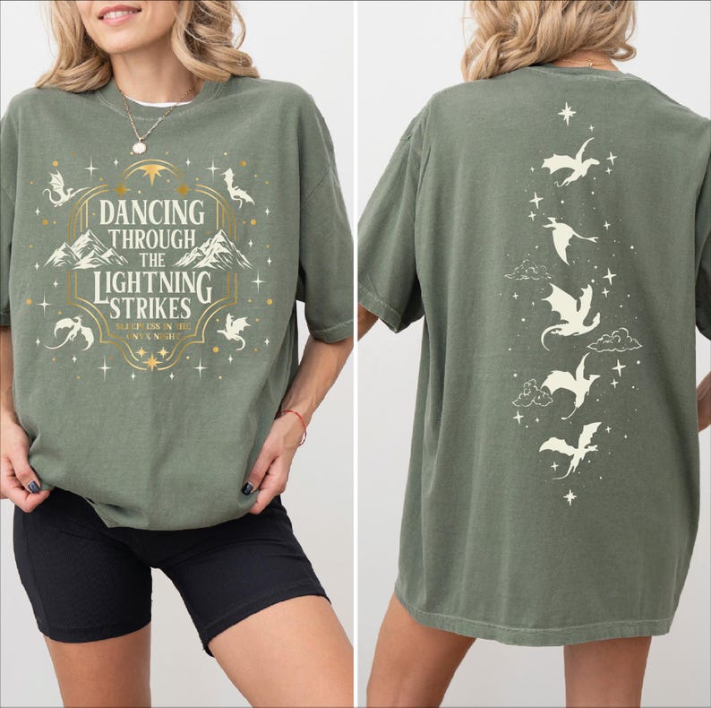 A woman wearing a green t-shirt with a design featuring a dragon and stars.