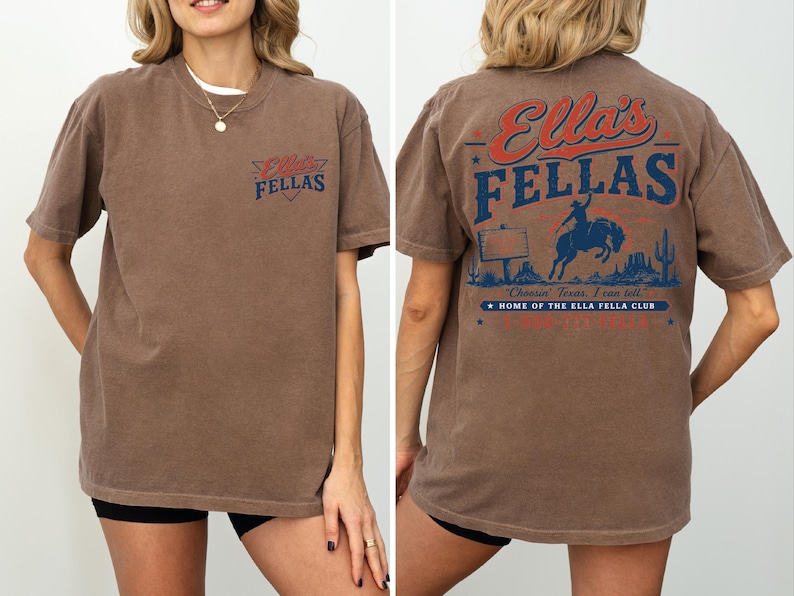 A woman wearing a brown t-shirt with a graphic design on the back.