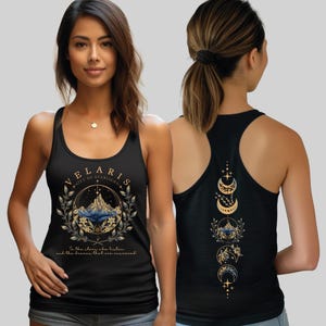 A woman wearing a black tank top with a graphic design on the front and back.