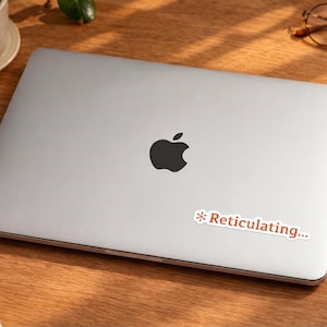 May include: A set of three ceramic nesting bowls in shades of blue, green, and white. The bowls have a speckled glaze and a simple, modern design. The largest bowl is about 15 cm in diameter.