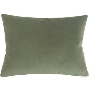 May include: A rectangular sage green pillow. The pillow has a soft, velvety texture and a simple, minimalist design. The pillow is a solid color and would be suitable for a bed or sofa.