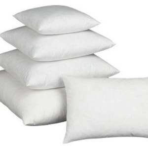 May include: A stack of six white pillows of varying sizes. The pillows are square and rectangular, with a soft, fluffy appearance. The pillows are arranged in a visually appealing manner, suggesting comfort and relaxation. The image is well-lit, highlighting the clean, crisp white fabric.