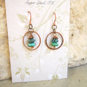 May include: Copper hoop earrings with turquoise and copper beads. The earrings are on a white card with the text "Jen's Bead Box Sugar Land, TX".