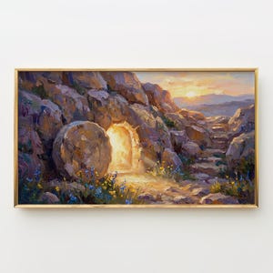 May include: A framed landscape painting depicts a stone tomb with an open entrance bathed in light. The artwork features a golden sunset over a rocky terrain with blue and yellow wildflowers. The painting is in a gold frame.