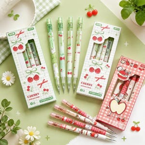 May include: Mechanical pencils with cherry and apple patterns, featuring two green boxes labeled CHERRY and one pink box labeled with an apple illustration, each containing four 0.5 mm pencils with matching fruit designs and gingham backgrounds.