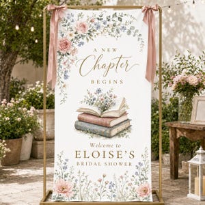 May include: A vertical rectangular banner featuring the text A NEW CHAPTER BEGINS and Welcome to ELOISE'S BRIDAL SHOWER. The design includes illustrations of stacked books with flowers, pink roses, and blue wildflowers, suspended on a gold metal frame.