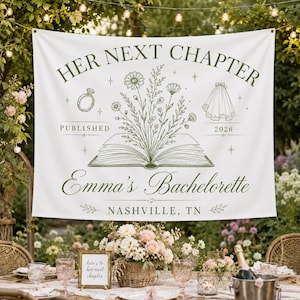 May include: A white fabric banner featuring dark green text and illustrations. The text reads HER NEXT CHAPTER, PUBLISHED 2026, Emma's Bachelorette, and NASHVILLE, TN. Graphics include an open book with flowers, a ring, and a wedding veil.