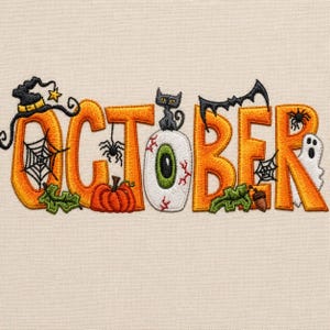 May include: An embroidery design spelling OCTOBER in orange letters on a light fabric. The O features a witch hat and spiderweb, the C has a spider and pumpkin, the T is an eyeball with a black cat, the O has a bat, the B has a spiderweb, and the R has a ghost.