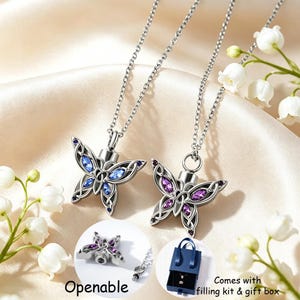May include: Two silver-toned butterfly pendants on chains, one with blue marquise-cut stones and one with purple stones. The pendants feature intricate metalwork and are openable. Text includes Openable, Comes with filling kit & gift box.