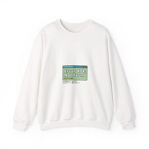 May include: White crew neck sweatshirt featuring a graphic of a computer error message. The message reads "Error 404: Not Found" in a green and yellow box. The sweatshirt is a plain white colour.