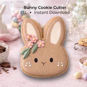 May include: A bunny-shaped cookie with a light brown base, decorated with pink flowers and green leaves. The cookie has black eyes and white dots. The text "Bunny Cookie Cutter" and "Instant Download" are visible.