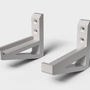 May include: Two light gray, L-shaped shelf brackets. Each bracket has a vertical section with two holes and a horizontal section with a recessed area. The brackets are made of a solid material and are designed for wall mounting.