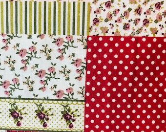 May include: A patchwork fabric with a variety of floral patterns in shades of pink, red, and green. The fabric features a red and white polka dot pattern, a red and white checkered pattern, and a green and white striped pattern.