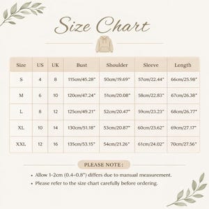 May include: A size chart for a hoodie, with measurements in inches and centimeters. The chart includes sizes S to XXL, with bust, shoulder, sleeve, and length measurements. The text "Size Chart" is at the top.