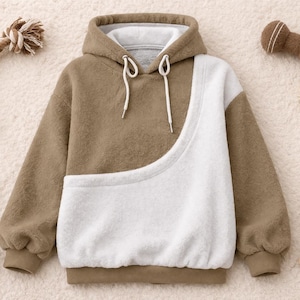 May include: A brown and white hoodie with a kangaroo pocket, surrounded by dog toys and a bowl of kibble. The hoodie has a drawstring hood and ribbed cuffs. The dog toys include a rope toy, a star-shaped toy, and a bone-shaped toy.