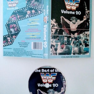 May include: A DVD case and disc for "The Best of the WWF Volume 20." The case is light blue with images of wrestlers and the WWF logo. The disc features the WWF logo and a wrestler image. The DVD set includes the 16 Man Battle Royal.
