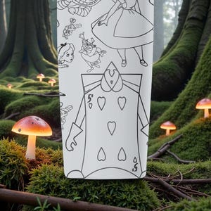 May include: A white tumbler featuring black line art illustrations of characters from Alice in Wonderland. The design includes Alice, the Queen of Hearts, and other whimsical figures. The background shows a forest scene with glowing mushrooms.
