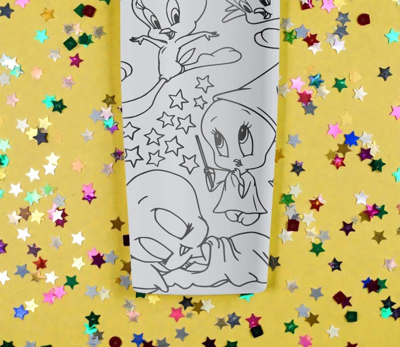 May include: A white rectangular object featuring black line art of cartoon characters, including Tweety Bird, stars, and other whimsical designs. The background is yellow with colorful star-shaped confetti.
