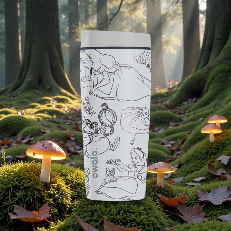 May include: A white Owala insulated water bottle featuring black line art illustrations of characters from Alice in Wonderland. The bottle has a gray lid and the Owala logo on the side. The background shows a forest scene with mushrooms.
