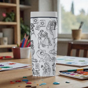 May include: A white tumbler featuring black line art illustrations of characters and elements from a popular animated movie. The design includes images of a princess, a chameleon, and other characters. The tumbler has a white lid and a black rim.