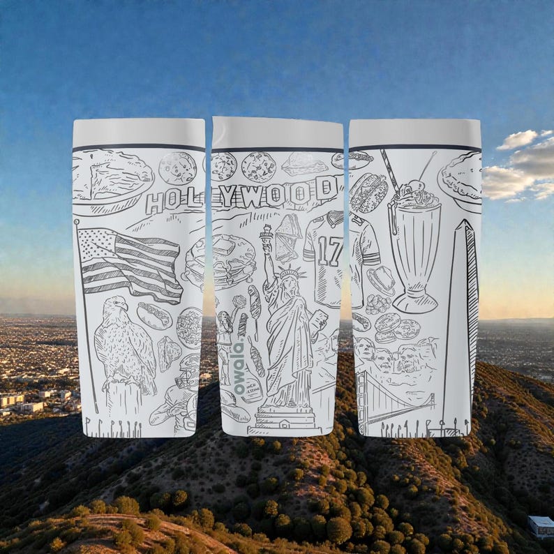 May include: Three white travel mugs with black line drawings of American landmarks and icons. The drawings include the Hollywood sign, the Statue of Liberty, an American flag, and a football jersey. The mugs have a white lid and a black band.
