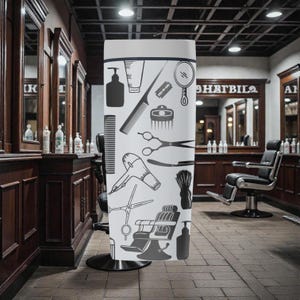 May include: A white barber shop display stand featuring black silhouettes of barber tools, including scissors, razors, and hair dryers. The stand is in a barber shop setting with chairs and mirrors.