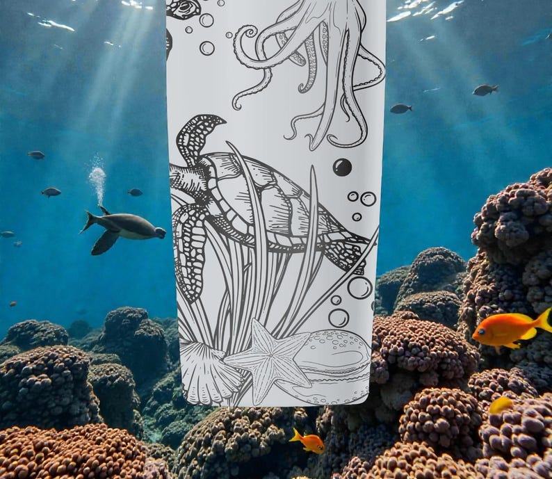 May include: A white tumbler with a black and white illustration of an octopus, sea turtle, starfish, and other marine life. The design is set against an underwater scene with coral and fish.