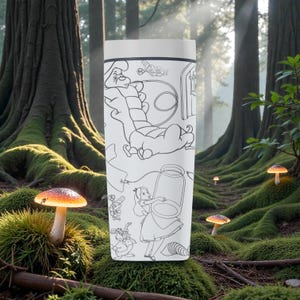 May include: White travel mug featuring black line art illustrations of characters from Alice in Wonderland. The design includes Alice, the Caterpillar, and other iconic elements. The mug has a white lid and a cylindrical shape.