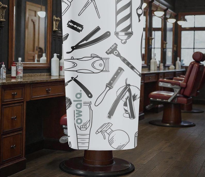 May include: A white barber shop chair cover featuring a repeating pattern of barber tools in black and gray. The tools include clippers, razors, combs, and a barber pole. The word "owala" is printed on the cover.