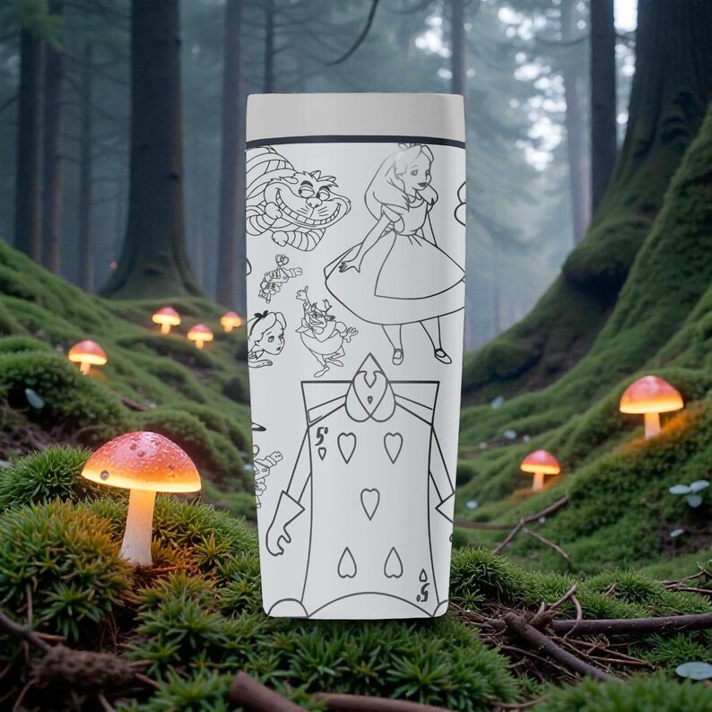 May include: A white travel mug featuring black line art illustrations of characters from Alice in Wonderland. The design includes the Cheshire Cat, Alice, the Queen of Hearts, and other characters. The mug has a light gray lid.