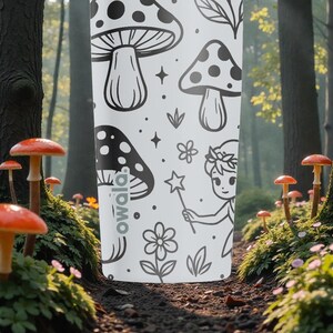 May include: White water bottle featuring a black and white design of mushrooms, flowers, and a fairy. The bottle has a repeating pattern of illustrations. The word "owala" is printed on the side of the bottle.