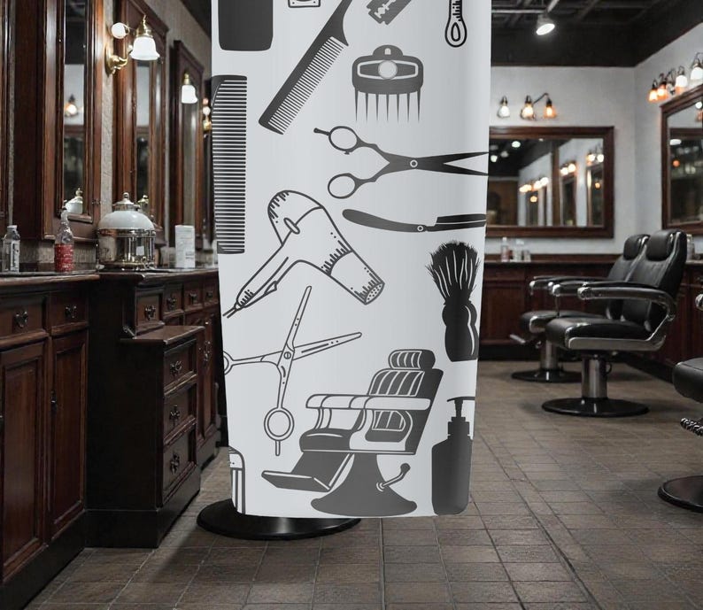 May include: A white shower curtain featuring a barber shop theme with black illustrations of combs, scissors, a hair dryer, and a barber chair. The curtain is displayed in a barber shop setting.