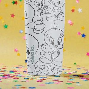 May include: A white Owala water bottle featuring black and white line art of Tweety Bird and other Looney Tunes characters. The bottle has a variety of star shapes and the word "owala." The background is yellow with colorful confetti.