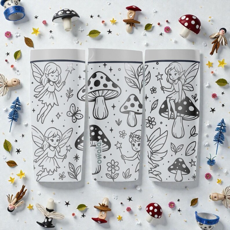 May include: Three white water bottles with black line art of fairies, mushrooms, and leaves. The bottles are surrounded by miniature mushroom figurines, stars, and leaves. The bottles have the word "owala" printed on them.