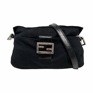 May include: Black shoulder bag with a leather strap. The bag features a silver buckle and a rectangular logo on the front. The bag is made of a soft material.