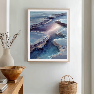May include: Abstract art print in a wooden frame. The artwork features a celestial landscape with blue, purple, and gold tones. The image depicts a river-like formation with textured edges, creating a sense of depth and movement. The overall theme is nature and abstract art.