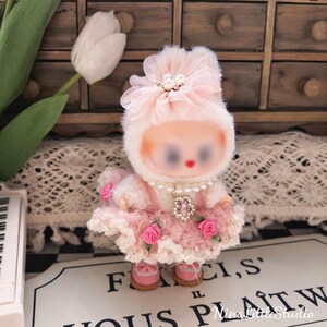 Close up details of handmade pink crochet rose outfit