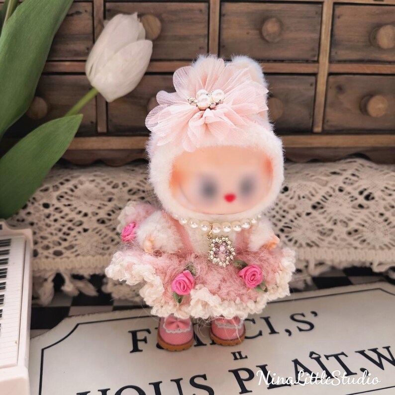 Close up details of handmade pink crochet rose outfit