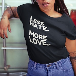May include: A black t-shirt with white text that reads "Less Hate. More Love."