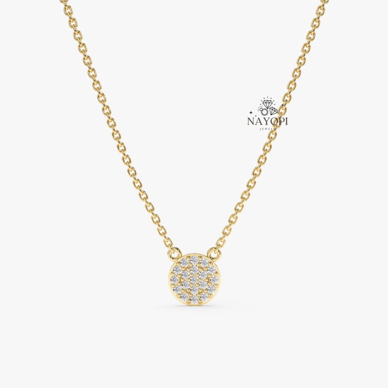 Dainty round diamond cluster necklace in yellow gold with delicate chain.