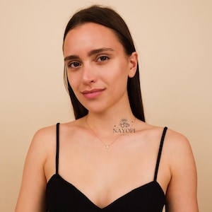 Delicate gold diamond cluster necklace perfect for layering jewelry.