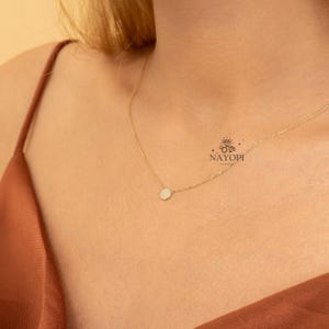 Minimalist gold diamond cluster pendant necklace with small round stones.