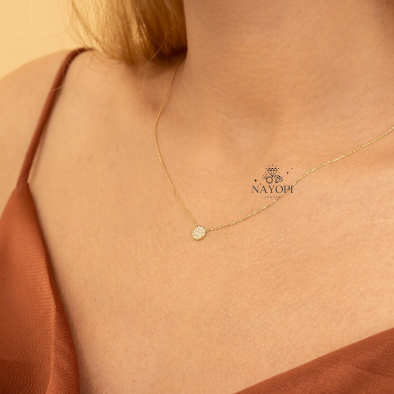 Minimalist gold diamond cluster pendant necklace with small round stones.