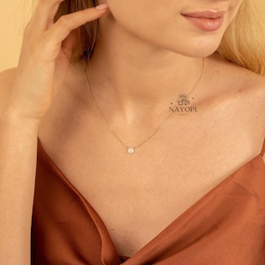 Elegant round pave diamond pendant necklace in solid yellow gold.