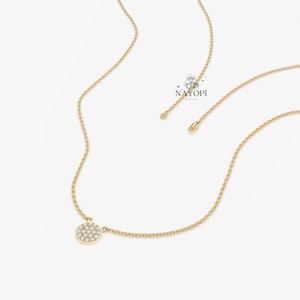 Elegant pave diamond circle necklace in yellow gold minimalist style.