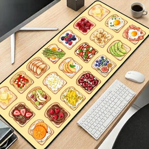 May include: A rectangular desk mat featuring a repeating pattern of various toast slices topped with ingredients including butter, fried eggs, bacon, berries, sliced fruits, vegetables, avocado, and chocolate spread on a light yellow background.