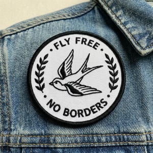 May include: A handmade wooden sign with the text "Welcome" in a handwritten style. The sign is painted white with a distressed finish, and a small green leaf is attached to the top. The sign measures approximately 12 inches wide.