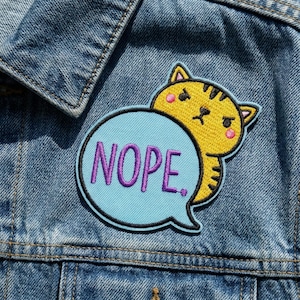 May include: A set of three ceramic mugs with a speckled, matte finish. The mugs are in shades of cream, light gray, and dark gray. Each mug has a simple, minimalist design, perfect for coffee or tea.