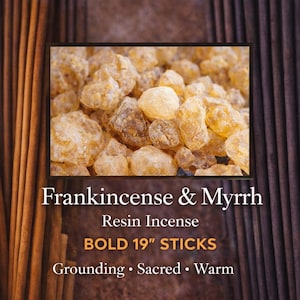 May include: The image features frankincense and myrrh resin incense. The text reads "BOLD 19" STICKS". The background includes vertical brown incense sticks and a dark brown textured surface. The image also includes the words "Grounding, Sacred, Warm".